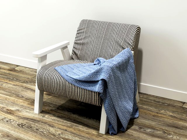 ozy comfortable chair with a knitted blanket