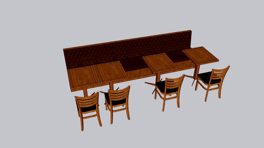 BOOTH COM CAPITONE NA PAREDE COM MESAS E CADEIRAS