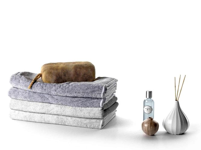 Stack of Towels with Bag Perfume and Vase