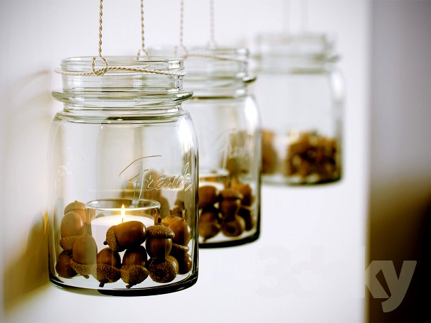Decorative candle in a jar with acorns