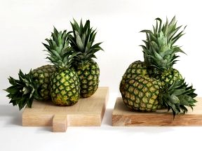 Pineapples on Wooden Board