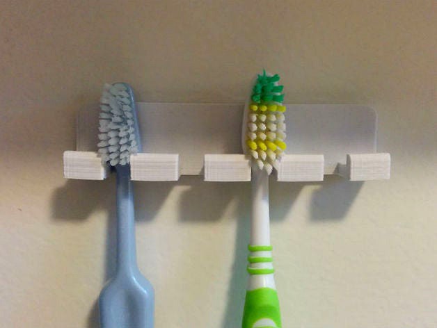 Wall-mounted toothbrush holder with rounded corners by LeifA