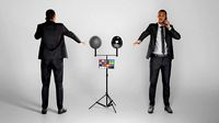 Young man in black suit talking on mobile phone 257