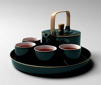 tray with green antique oriental kettle and cups with tea