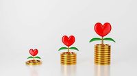 3d money tree plant love or red heart on stack of coin