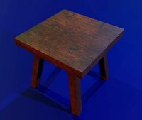 A wooden chair with scuffs and abrasions