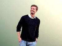 Andrew 10607 - Man Walking And Smiling With Hands In Pockets