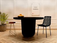 LOLA ROUND BLACK CONCRETE DINING TABLE CB2