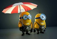Two minions under an umbrella