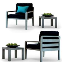 Curved wooden armchair with gray cushion and blue pillow.