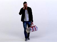 Mark 0454 Man carrying a duffel bag, talking on a phone