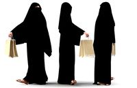Woman wearing Saudi Arabian hidshab posed holding shopping bags