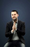 Portrait Casual Smart Man In A Black Jacket Sitting And Clapping