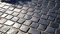 Black cobblestone pavement textur