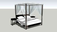 simple four poster bed with mosquito nets