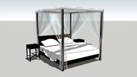 simple four poster bed with mosquito nets