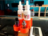 eJuice bottle and tank stand by realvapejay