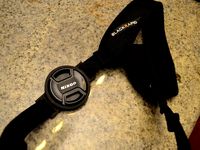 Lens cap holder for both 58 and 52 mm lens diameters by timsaucer