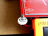 Prusa i3 bed adjuster with a direction arrow. by GilesBathgate