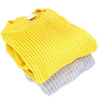Stack Of Folded Womens Sweaters 012